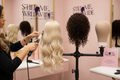 Stylist using wig stand